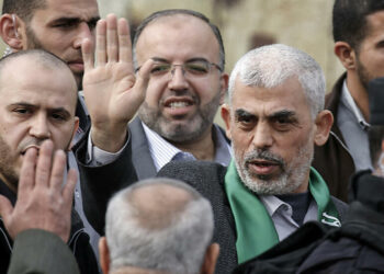 Hamas' leader in the Gaza Strip Yahya Sinwar (1st-R) waves upon his arrival at a rally marking the 31st anniversary of Hamas' founding, in Gaza City December 16, 2018. (Photo by SAID KHATIB / AFP)